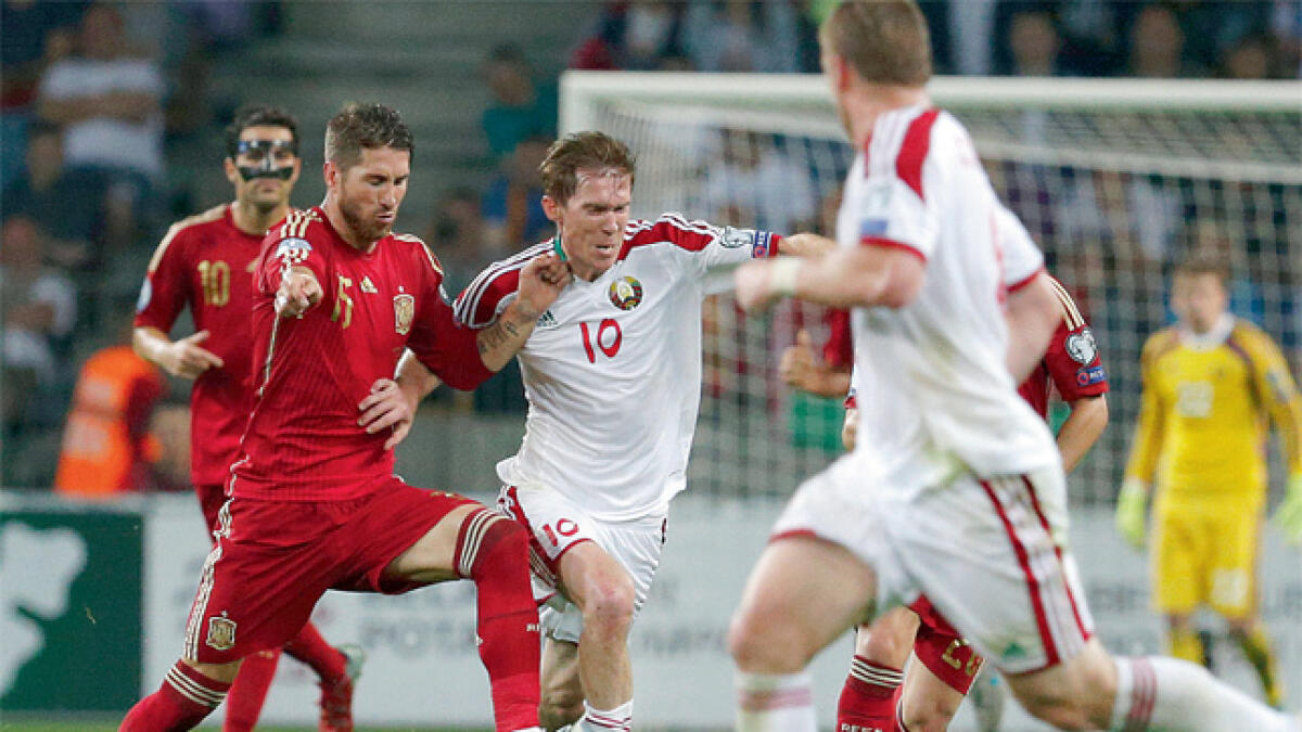 Spain survive a scare; Rooney the late hero