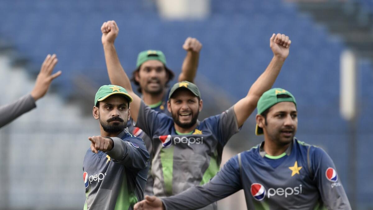 The Pakistan cricketers (left) and players from India seen during a training session ahead of their Asia Cup round-robin clash. — AFP