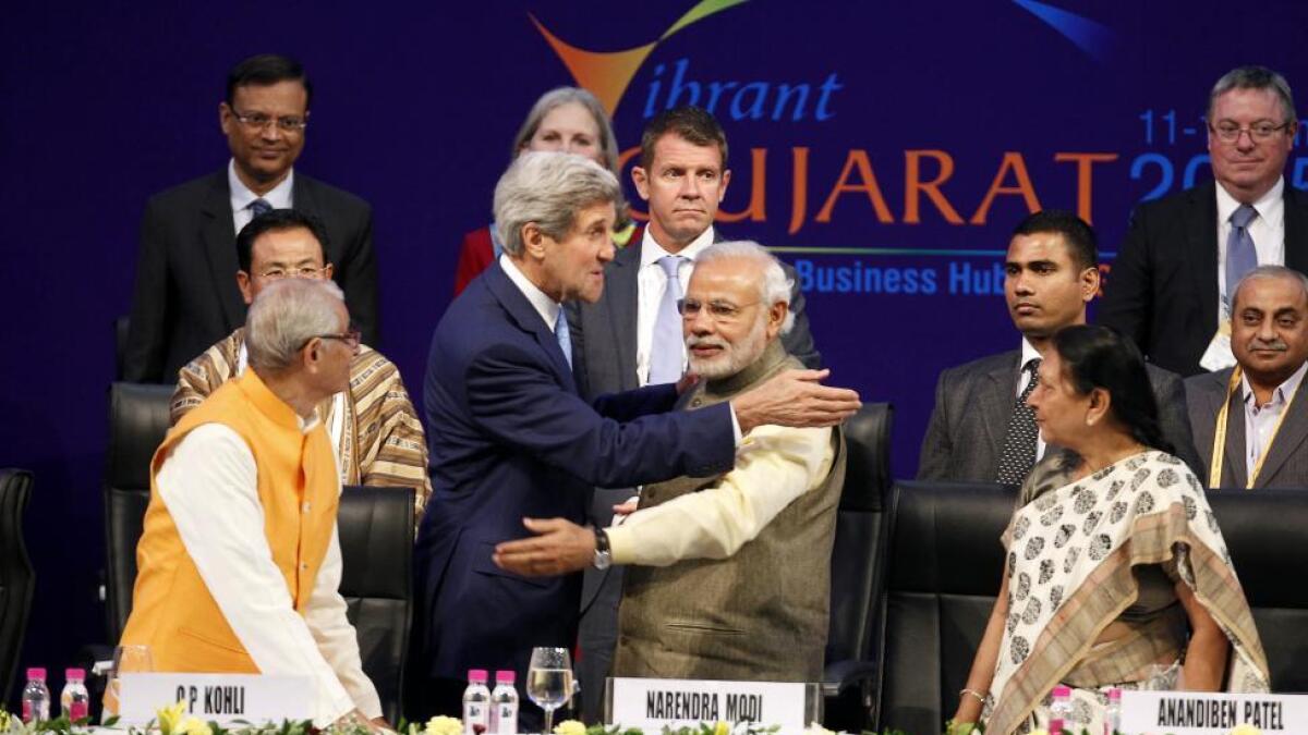 US Secretary of State John Kerry (front, 2nd L) and India's Prime Minister Narendra Modi (front, 2nd R) gesture after shaking hands at the Vibrant Gujarat Summit in Gandhinagar in the Gujarat January 11, 2015.