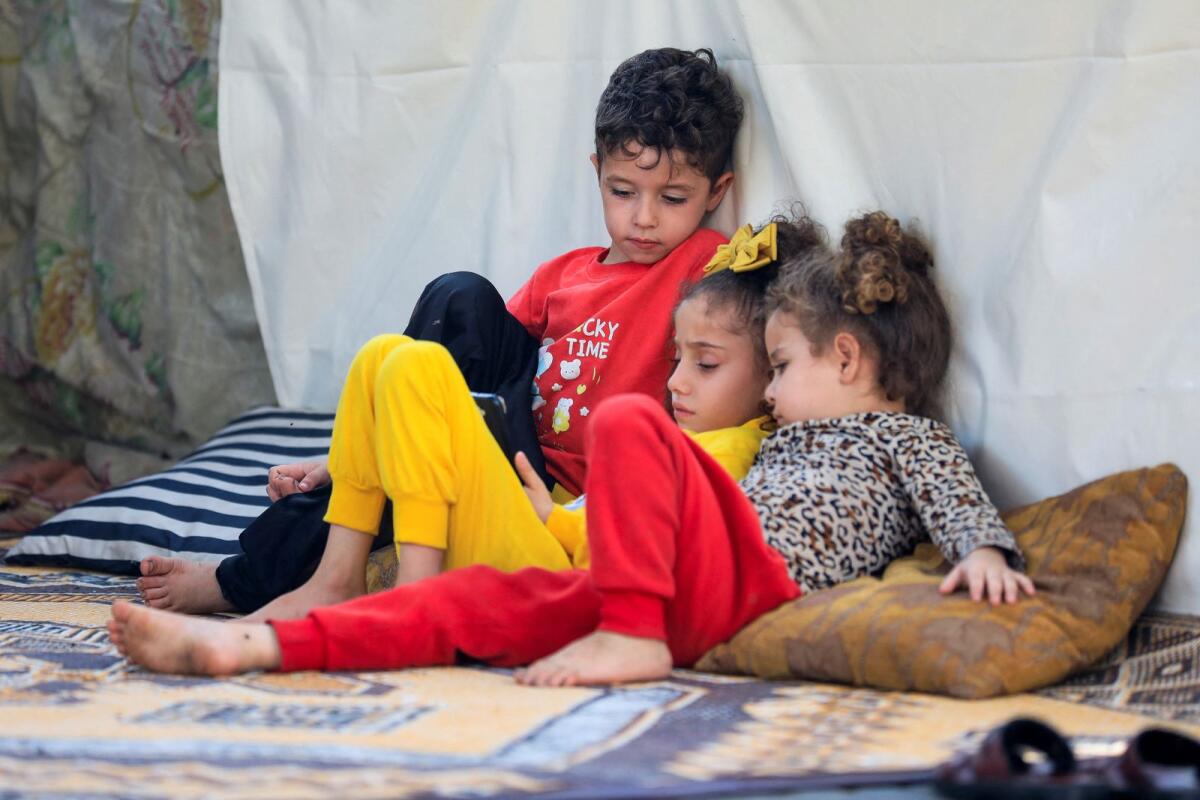 Displaced Palestinian children, who fled their house due to Israeli strikes, sit in a makeshift shelter at Shifa hospital. Photo: Reuters
