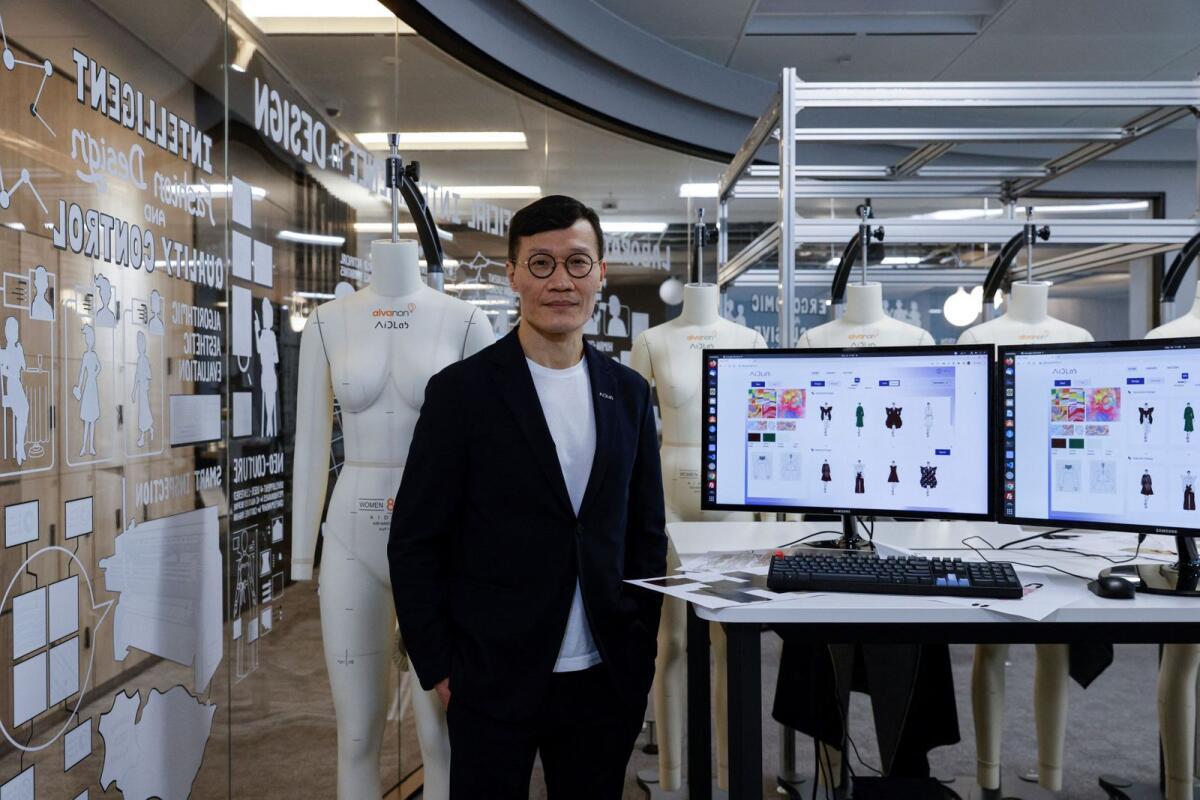 Chief Executive Officer and Centre Director of AiDALab, professor Calvin Wong poses with Aida system, before the 'Fashion X AI : Call For Young Talents 2022' fashion show in Hong Kong, China, on December 16, 2022. -- Reuters file