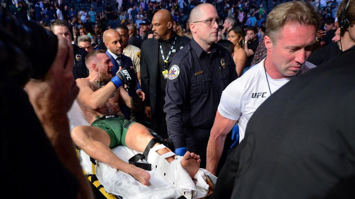 Conor McGregor is carried off a stretcher following an injury suffered against Dustin Poirier during UFC 264 at T-Mobile Arena. — Reuters