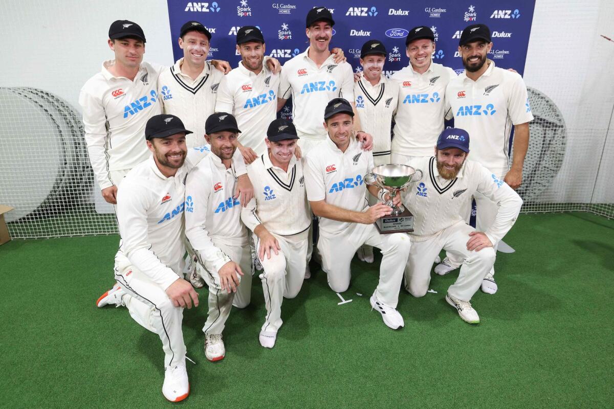 New Zealand players pose with the Test series trophy. — AFP