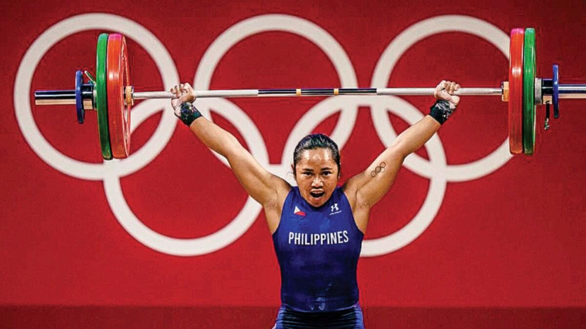 ... and Hidilyn Diaz its first Olympic gold champion. — AP, AFP