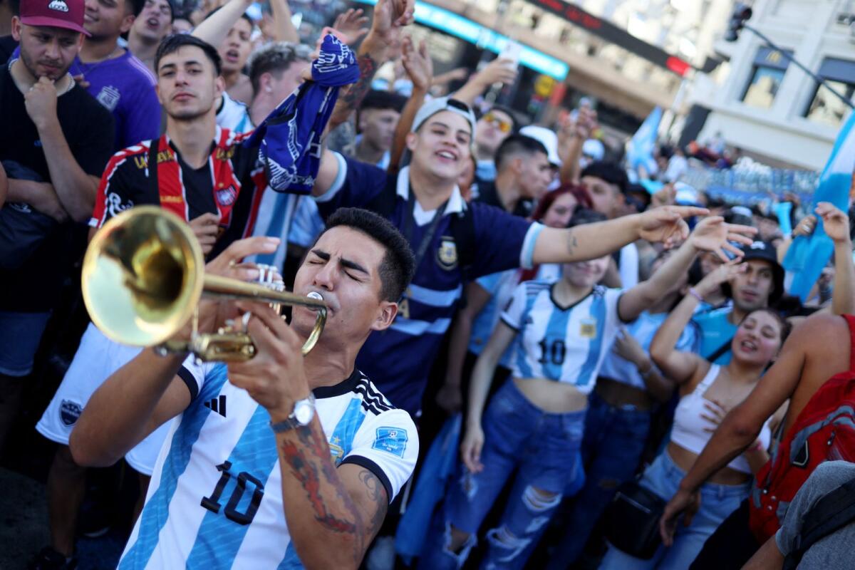 Argentina fan plays the trumpet ahead of the victory parade. Photos: Reuters