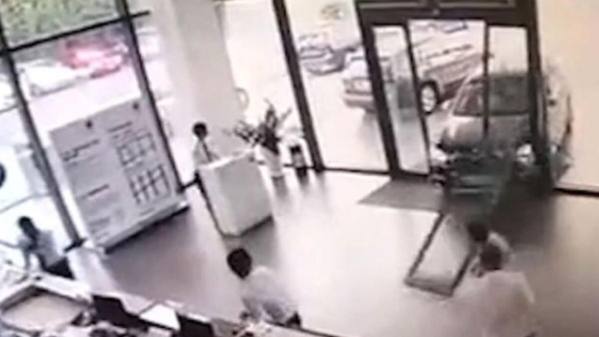 Video: Woman crashes BMW into  showroom during test drive
