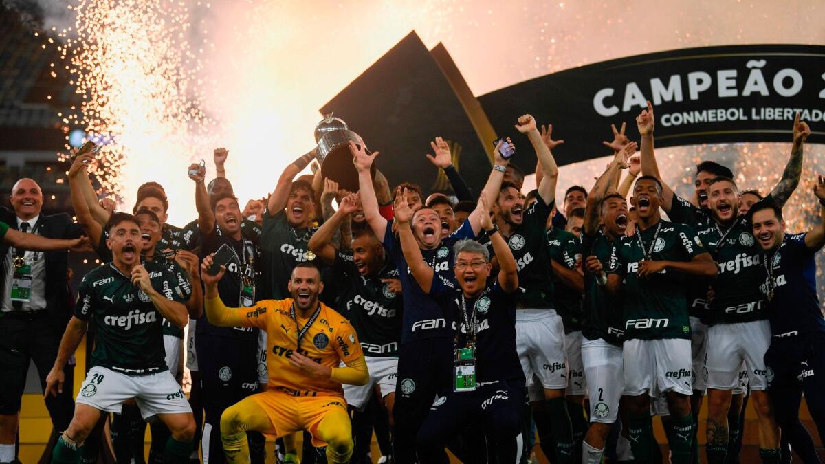 Palmeiras players and officials celebrate with the trophy on the podium after winning the Copa Libertadores tournament by defeating Santos in the all-Brazilian final. — AFP