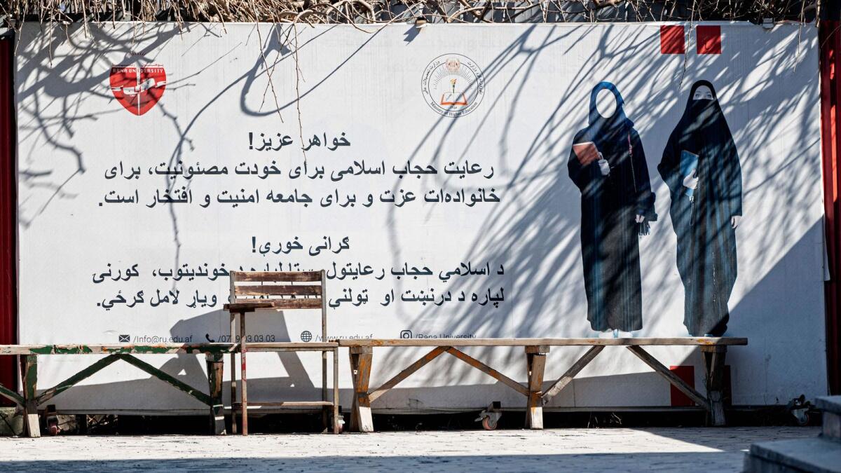 A banner ordering women to cover themselves with a Hijab is pictured at a private university in Kabul. — AFP file