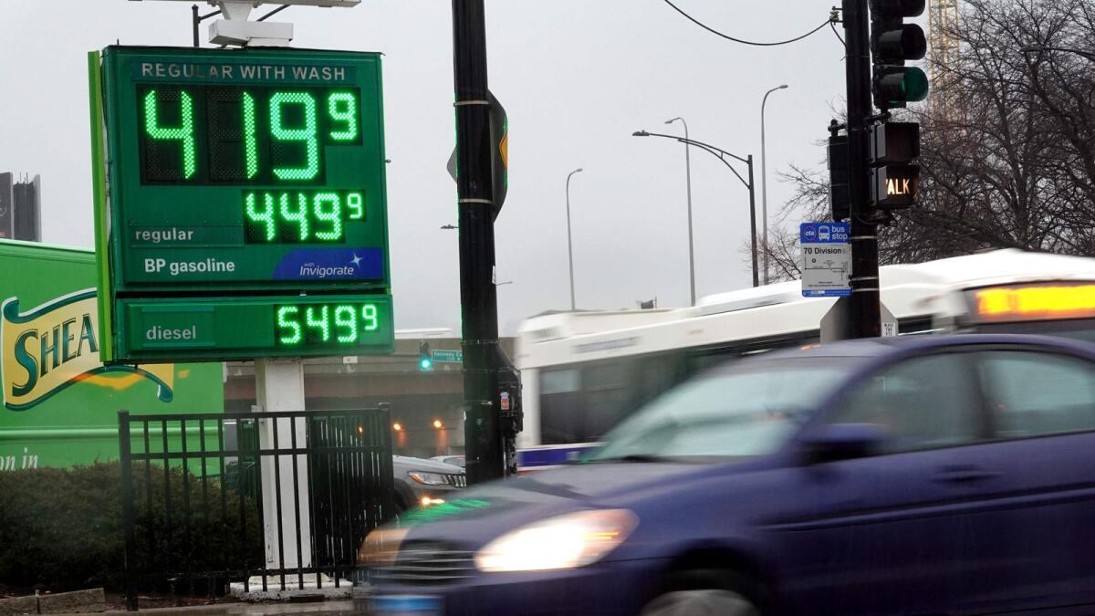 Fuel prices are displayed on a sign in Chicago, Illinois. Gasoline prices are likely to rebound in the months ahead. - AFP