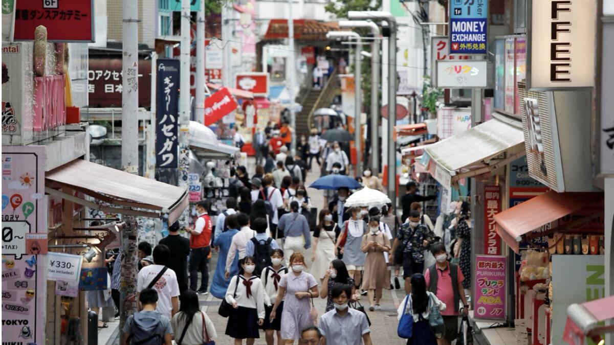 Passersby wearing protective face masks are seen at Takeshita Street, a popular sightseeing spot amid the coronavirus disease (Covid-19) outbreak in Tokyo, Japan. Photo: Reuters
