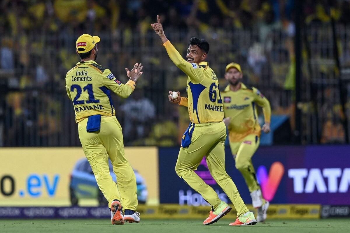 Chennai Super Kings' Maheesh Theekshana (centre) celebrates with teammates after taking a catch to dismiss Gujarat Titans' Dasun Shanaka. — AFP