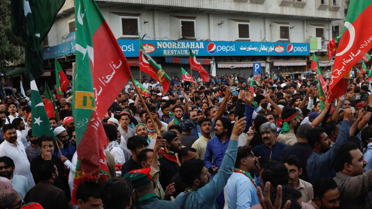 Supporters of the Pakistan Tehreek-e-Insaf (PTI) political party gather, after Pakistan Election Commission disqualified former Prime Minister Imran Khan on charges of unlawfully selling state gifts, during a protest in Karachi. — Reuters