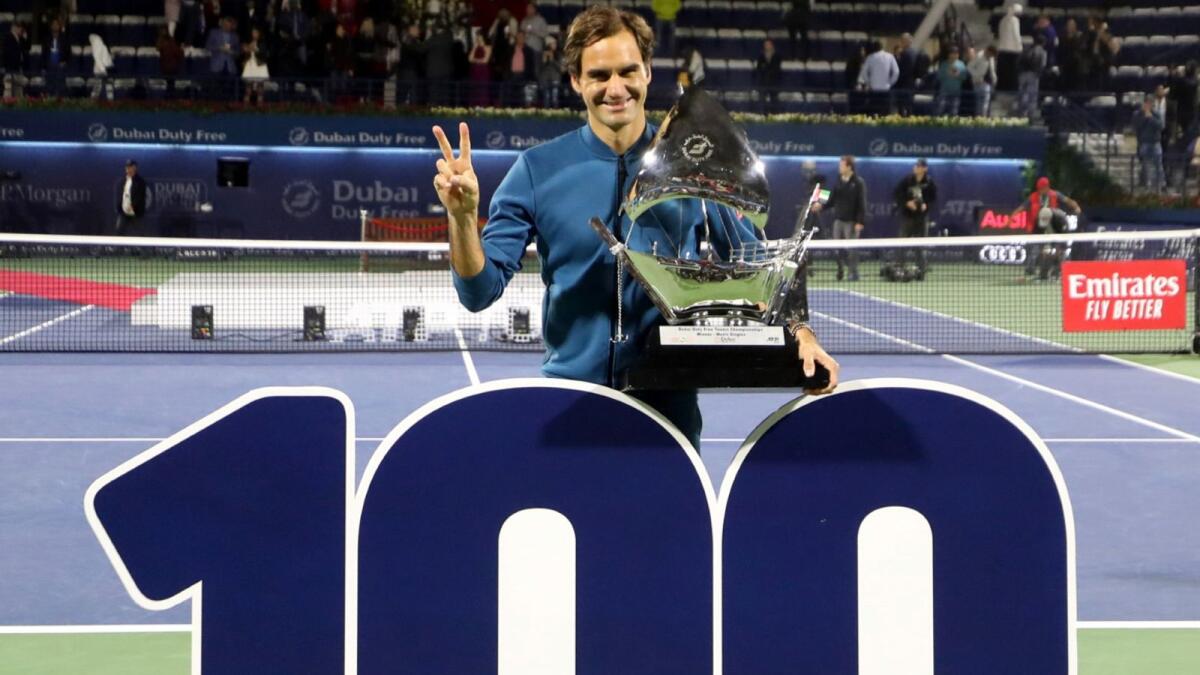 Roger Federer celebrates after winning his eighth Dubai title. It was also his 100th career title. (AFP)