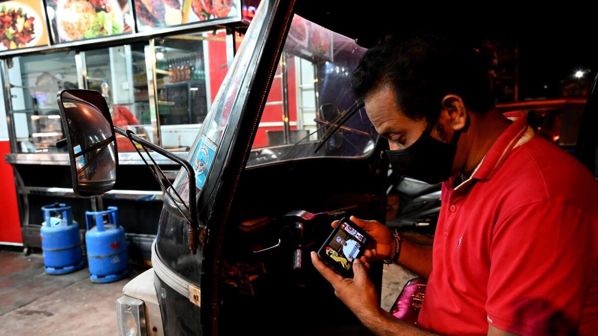 A man watches Sri Lankan President Gotabaya Rajapaksa address to the nation on his mobile in Colombo. _ AFP