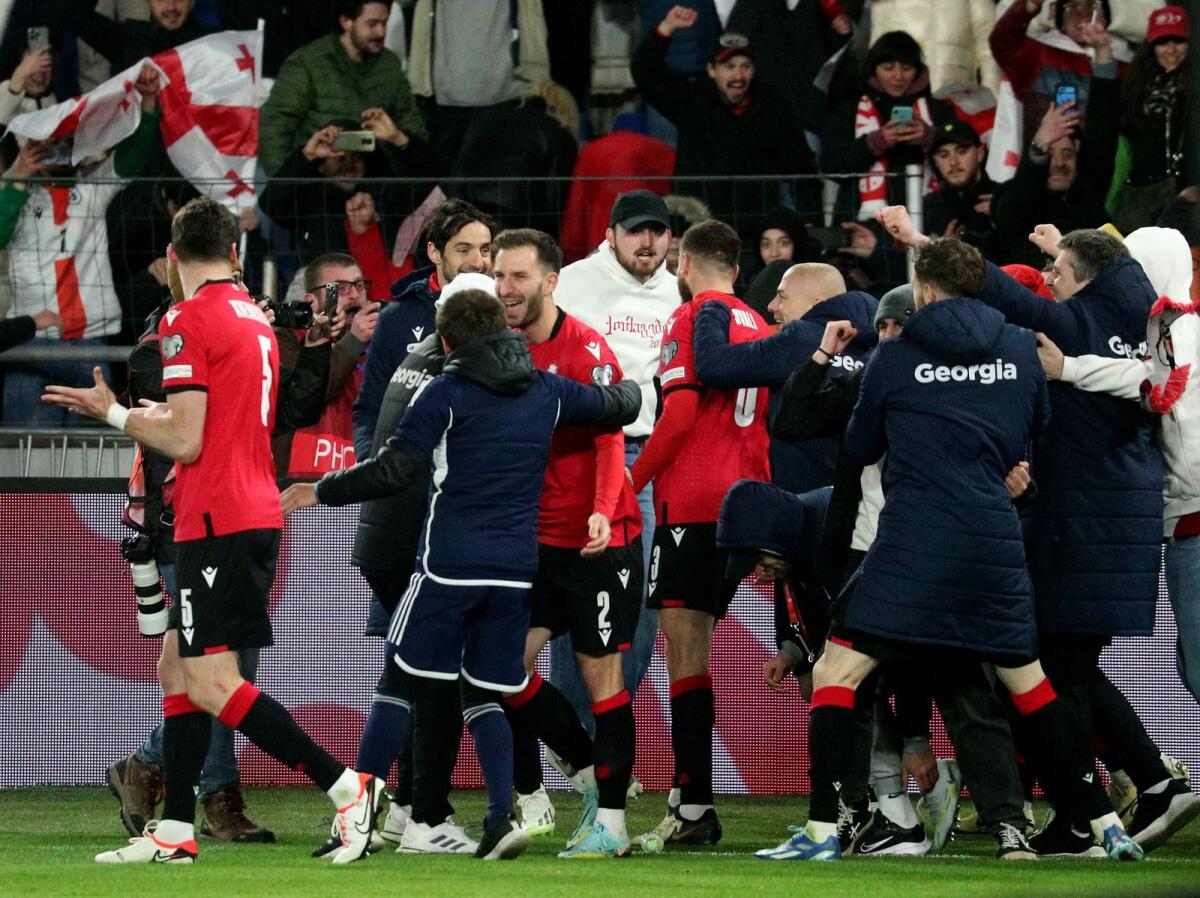 Georgia's players celebrate with fans. — Reuters