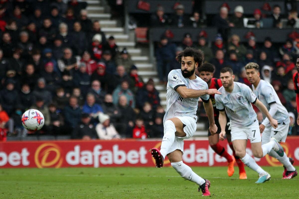 Liverpool's Mohamed Salah (left) takes a penalty against Bournemouth on Saturday. — AFP