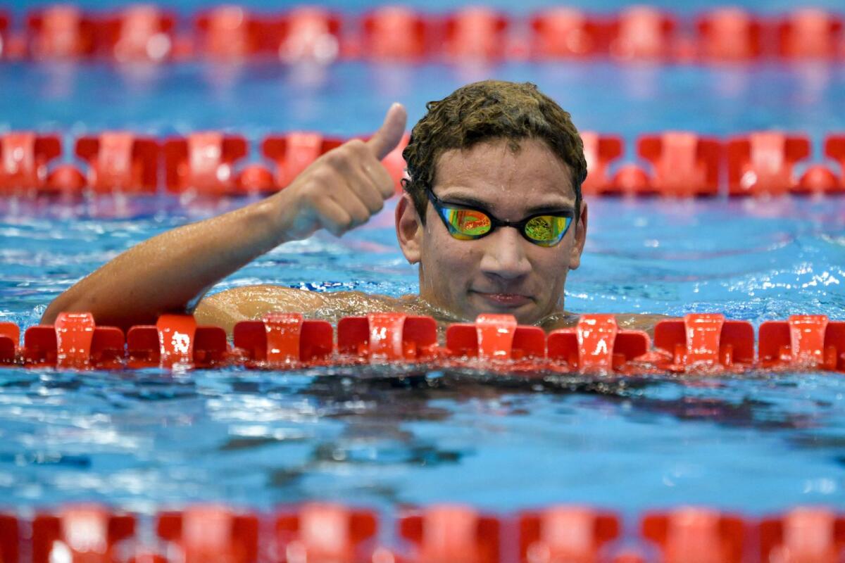 Tunisia's Ahmed Hafnaoui celebrates his victory in the final of the men's 1500m freestyle. — AFP