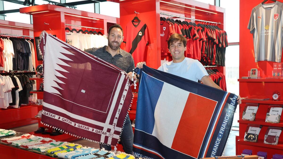 Bertrain Roine (left) with fan shemagh scarves, also known as ghutra or keffiyeh. — AFP