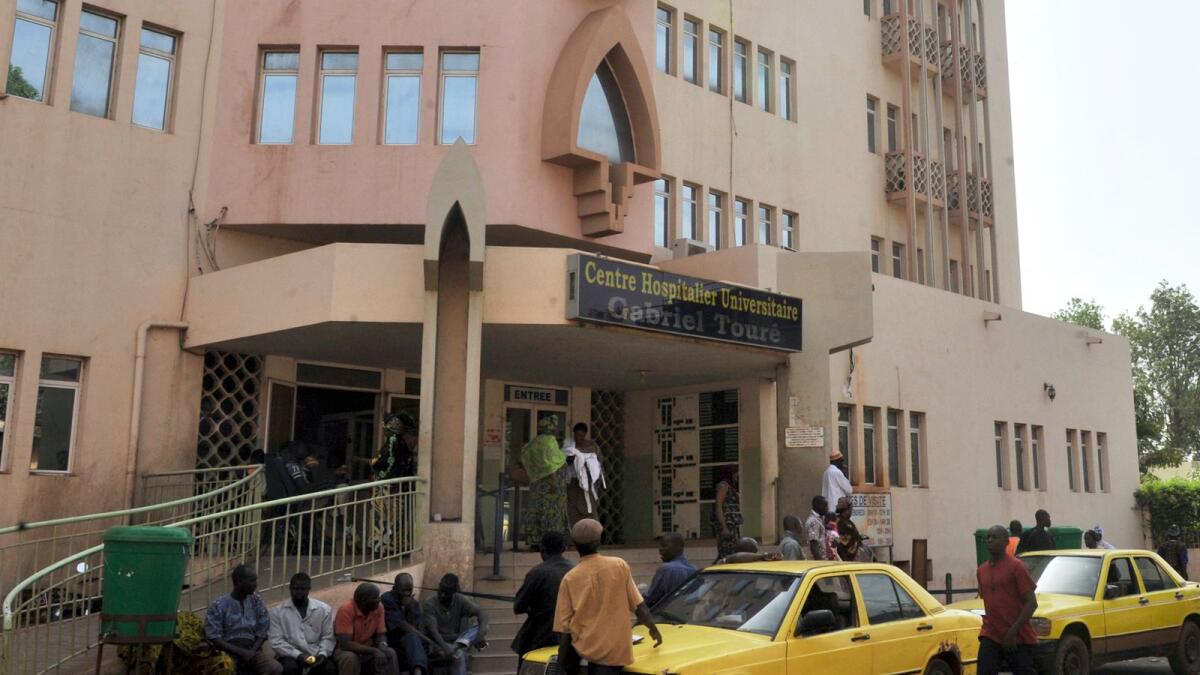 People walk past a hospital in the Mali capital Bamako. Photo: AFP