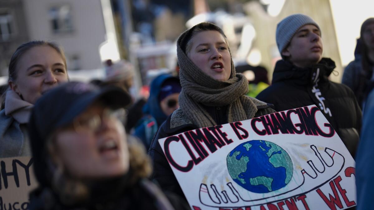 Demonstrators shout slogans during a demonstration against the World Economic Forum in Davos. — AP