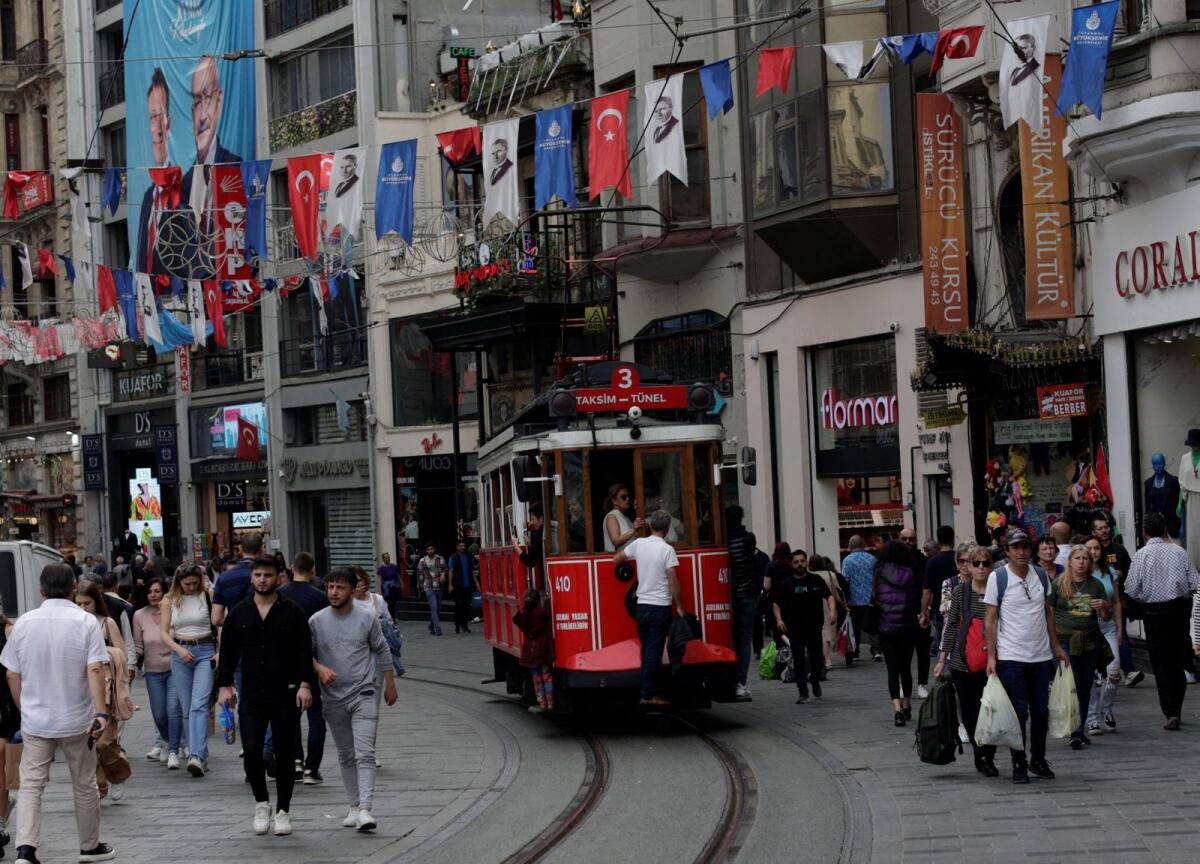 People walk at the main shopping and pedestrian street in Istanbul.