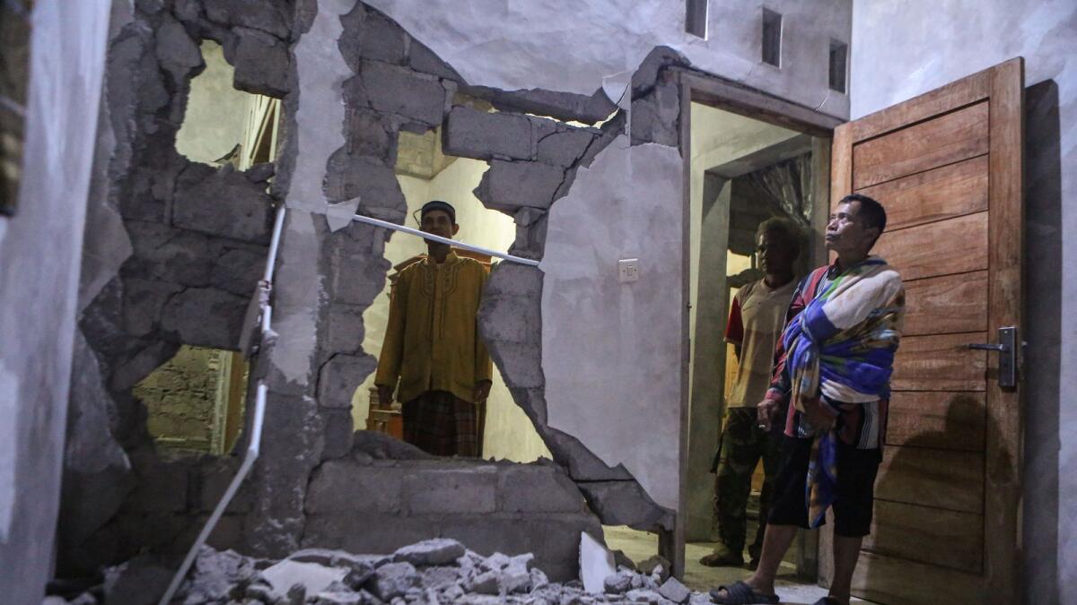 People stand inside a damaged house after an earthquake struck off theÊIndonesian island of Java in Pacarejo, Gunungkidul, Yogyakarta, Indonesia July 1, 2023. Photo: Reuters file