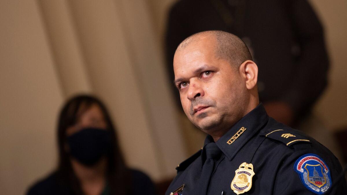 Aquilino Gonell, sergeant of the U.S. Capitol Police, watches a video of rioters during a hearing of the House select committee investigating the January 6 attack on the US Capitol. Photo: AFP