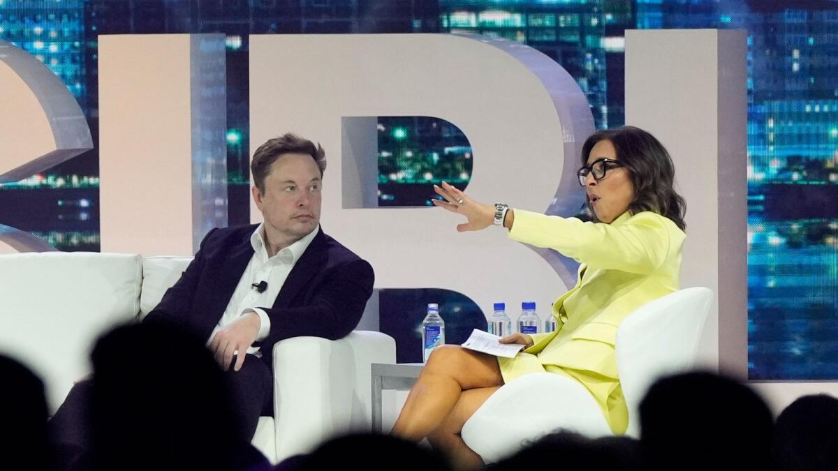 Twitter CEO Elon Musk speaks with Linda Yaccarino, chairman of global advertising and partnerships for NBC, at the POSSIBLE marketing conference on April 18, 2023 in Miami Beach, Florida. — AP file