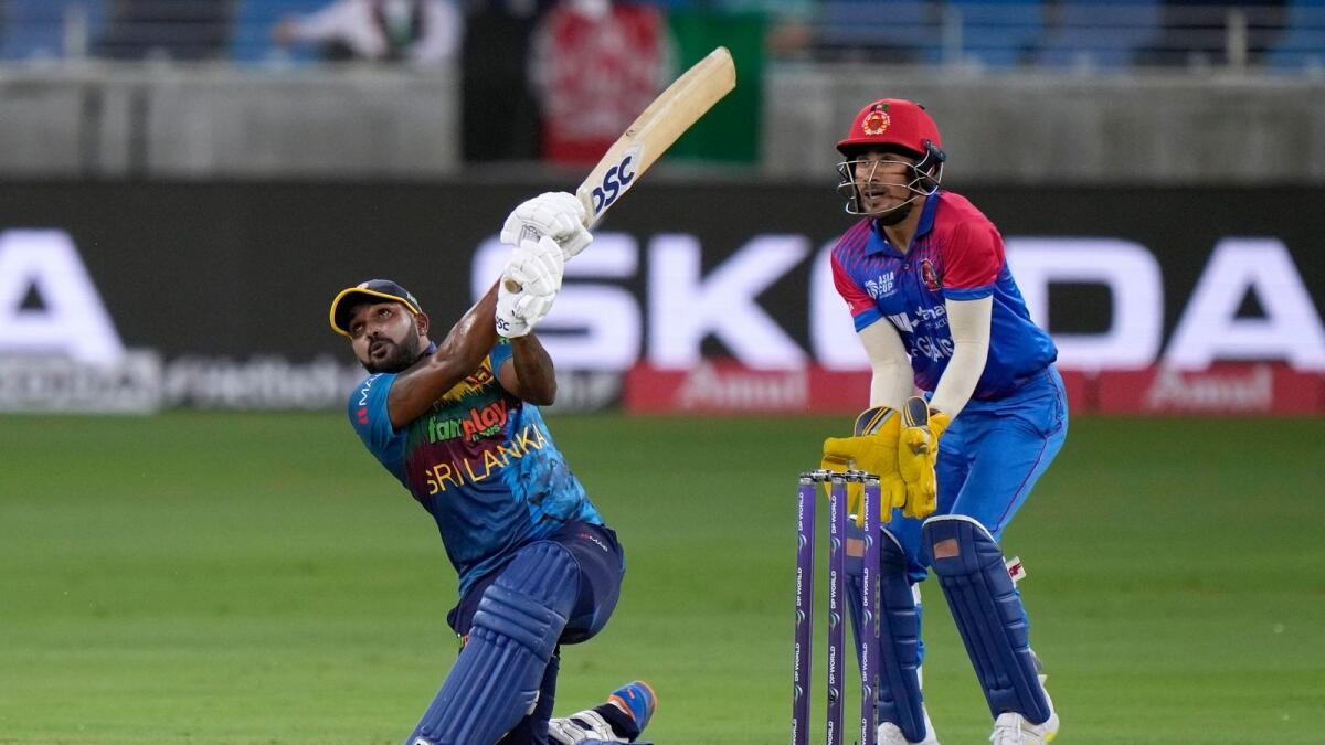 Sri Lanka's Wanindu Hasaranga (left) plays a shot during the match against Afghanistan in the opening match. (AP)