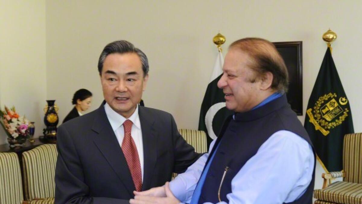 Pakistani Prime Minister Nawaz Sharif (R) shakes hands with visiting Chinese Foreign Minister Wang Yi in Islamabad, Pakistan 
