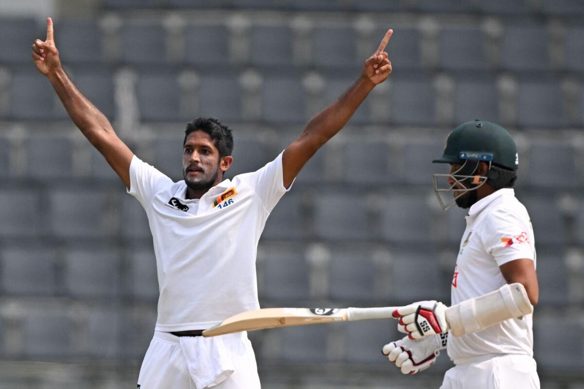 Sri Lanka's Kasun Rajitha (left) celebrates after taking the wicket of Bangladesh's Khaled Ahmed. — AFP