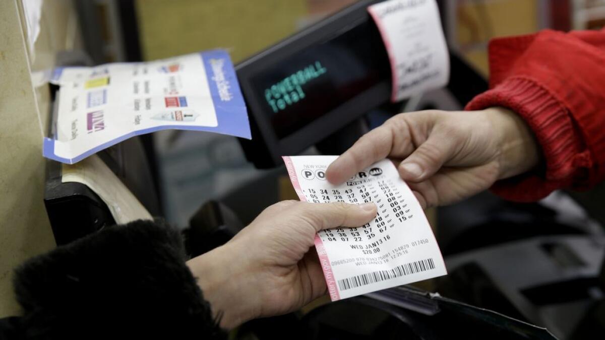 A woman buys a Powerball ticket in New York.