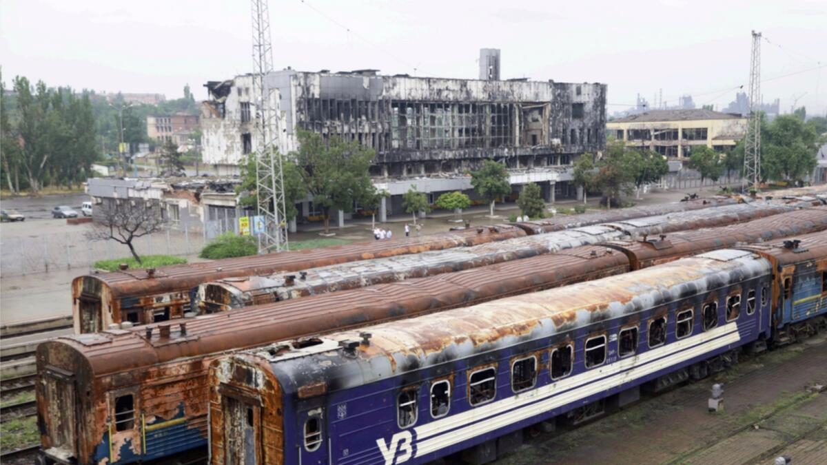 Burnt-out wagons stand on tracks at the station in Mariupol. — AP