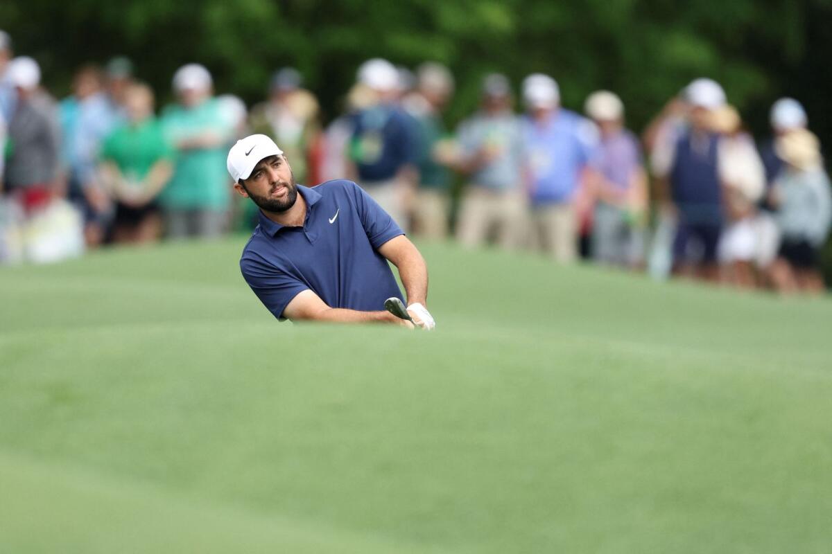 Scottie Scheffler of the United States chips to the eighth green during a practice round prior at Augusta National Golf Club. — AFP