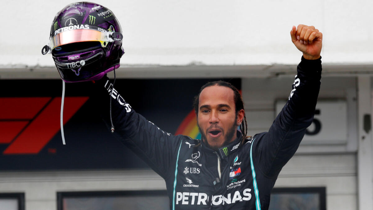 Mercedes' Lewis Hamilton celebrates after winning the Hungarian Grand Prix. - Reuters