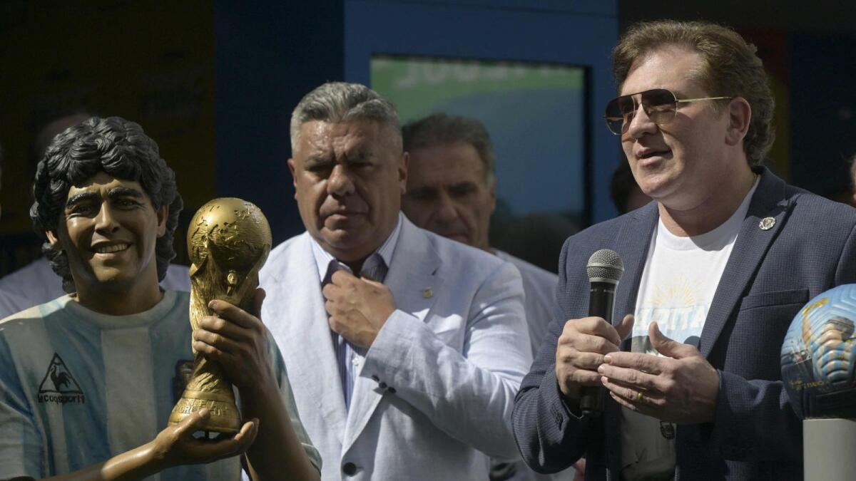 CONMEBOL's President Alejandro Dominguez (right) delivers a speech next to AFA's President Claudio Tapia during a tribute ceremony to late football star Diego Maradona on the second anniversary of his death, at CONMEBOL fan zone 'Tree of dreams' during the Qatar 2022 World Cup in Doha on Friday. — AFP