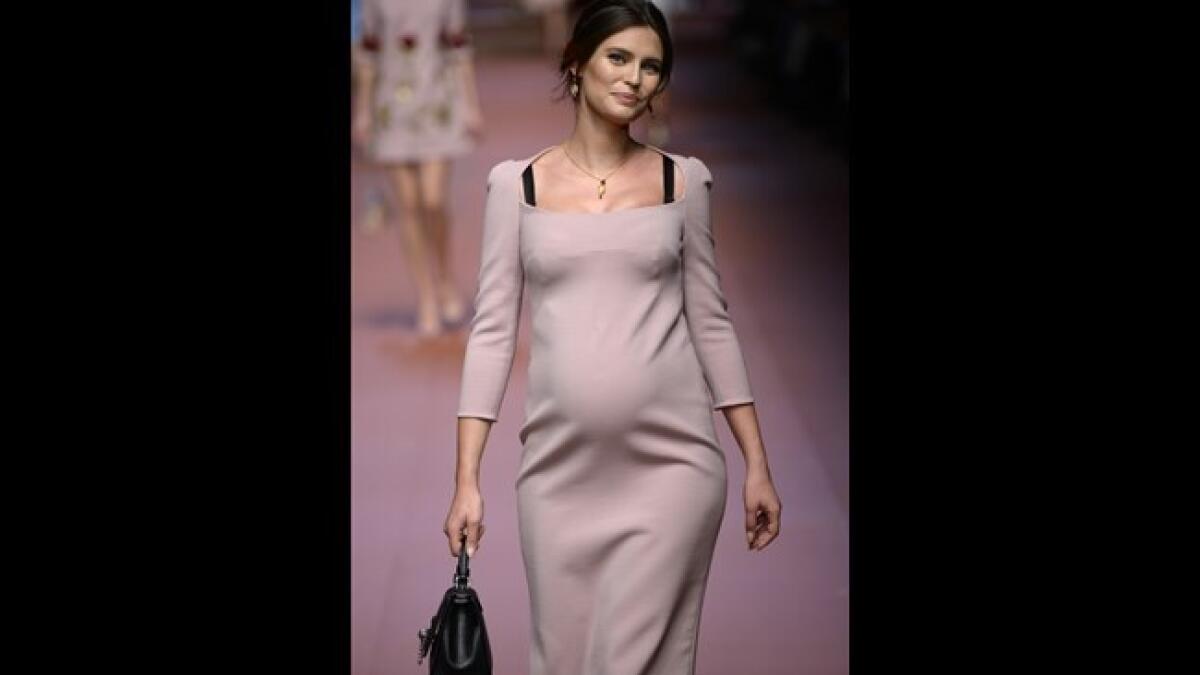 At Dolce and Gabbana's Milan Fashion Week show last year, pregnant Italian model Bianca Balti walked the catwalk in a fitted peach dress showing her bump.
