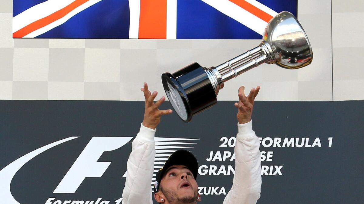 Lewis Hamilton celebrates his Japanese Grand Prix victory on the podium on Sunday. 
