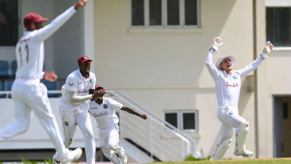 Joshua de Silva (right) takes the catch and Jason Holder (2nd left) of West Indies celebrates the dismissal of Kyle Verreynne of South Africa. — AFP