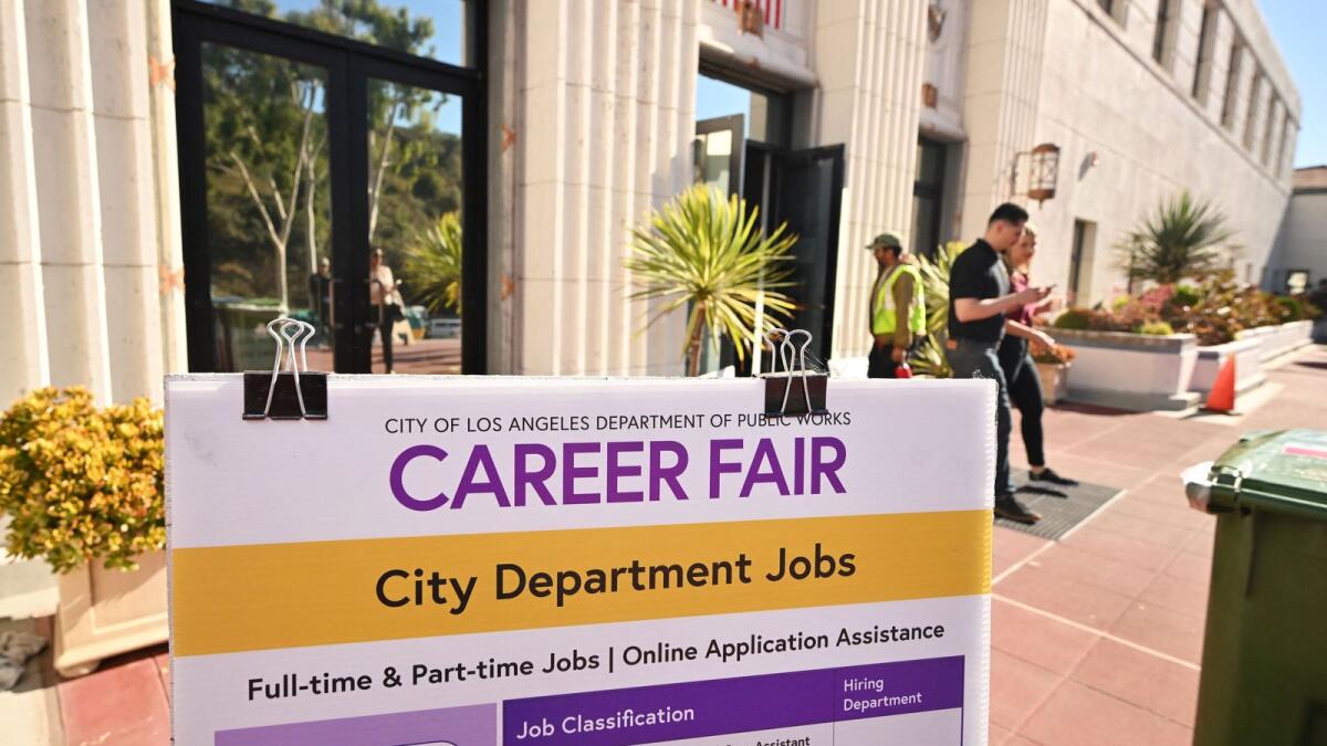 People enter and depart a career fair in Los Angeles. — AFP file