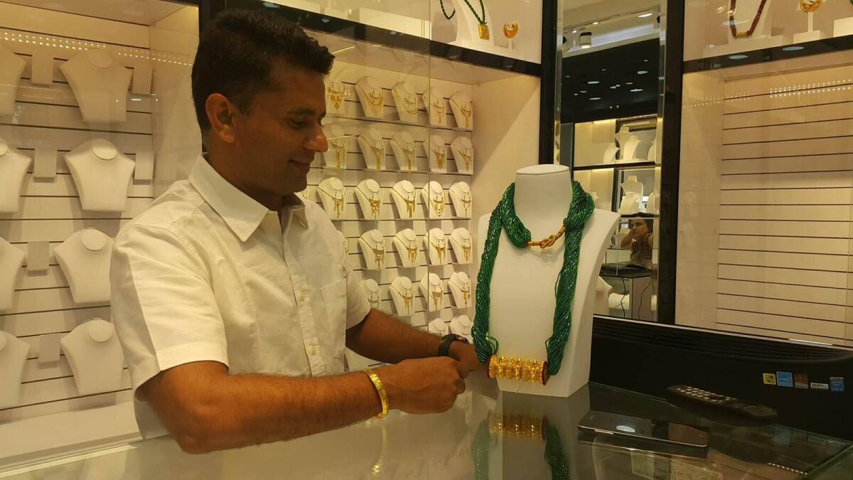 Store owner Roshan Bhusal shows Nepalese traditional design 'tillhari' to he customers
