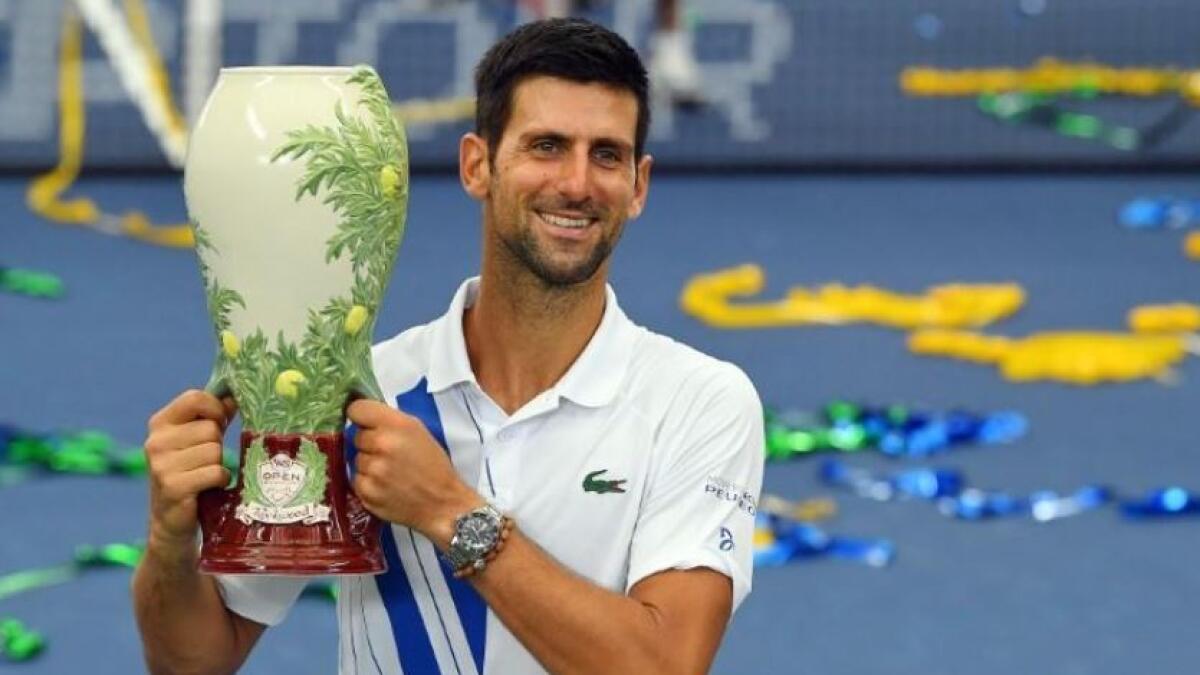 Novak Djokovic poses with the trophy following his win over Milos Raonic in the Western &amp; Southern Open final at the USTA Billie Jean King National Tennis Center. (Reuters)