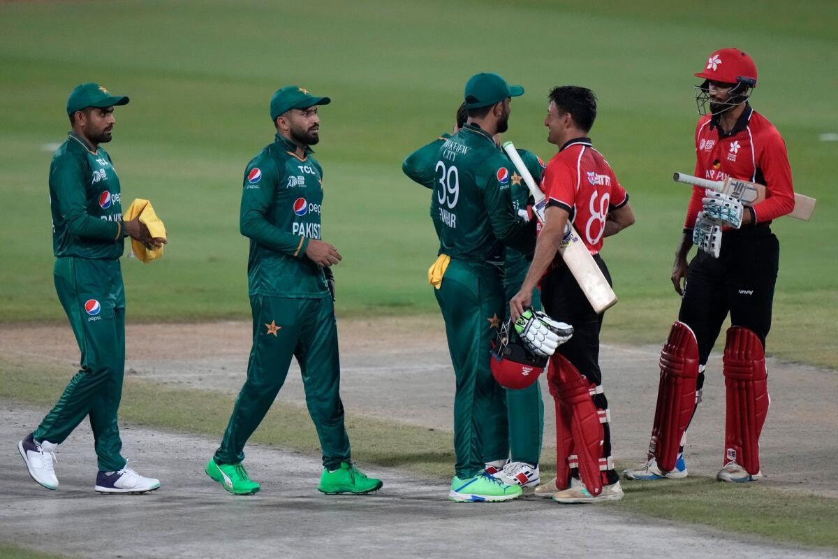 Hong Kong's Ehsan Khan (second right) congratulates Pakistan players after their Asia Cup match in Sharjah on Friday. (AP)
