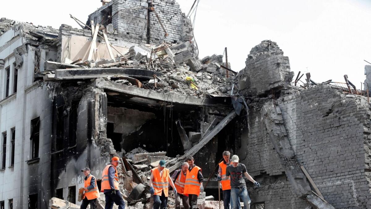 Emergency management specialists and volunteers remove the debris of a theatre building destroyed in Mariupol, Ukraine on April 25, 2022. (Photo: Reuters)