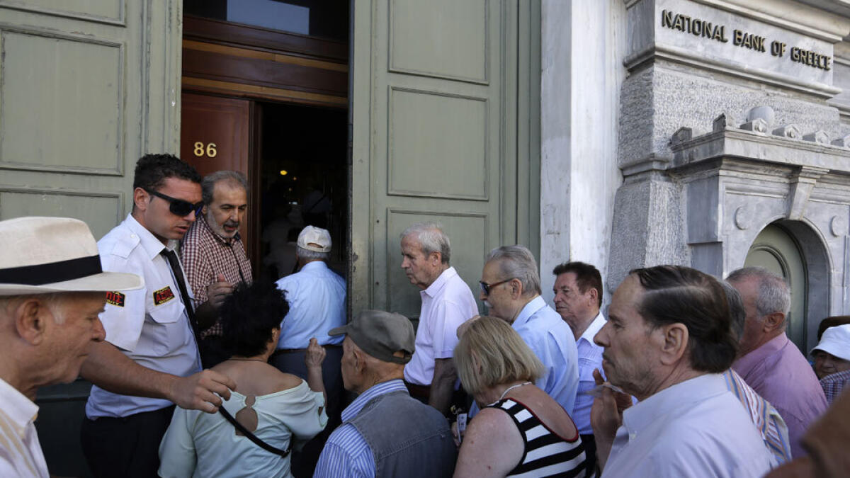 Banks reopen, taxes rise as Greece pays billions to creditors