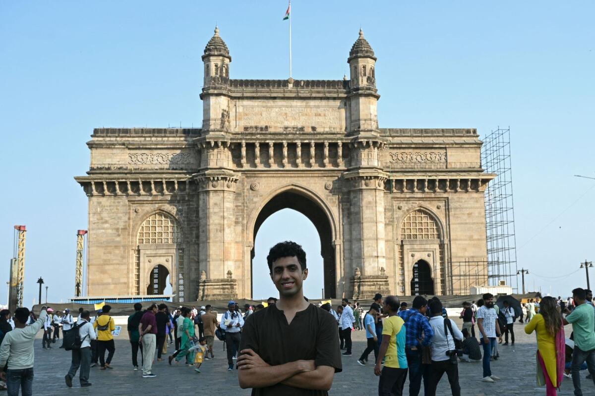 Abhishek Dhotre, a student who will be voting for the first time in India's upcoming general election, poses in front of the Gateway of India, in Mumbai. — AFP
