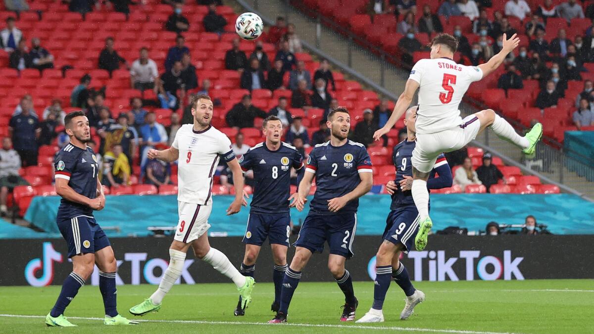 England's John Stones goes for a header during the Euro 2020 Group D match at the Wembley stadium in London on Friday. (AP)