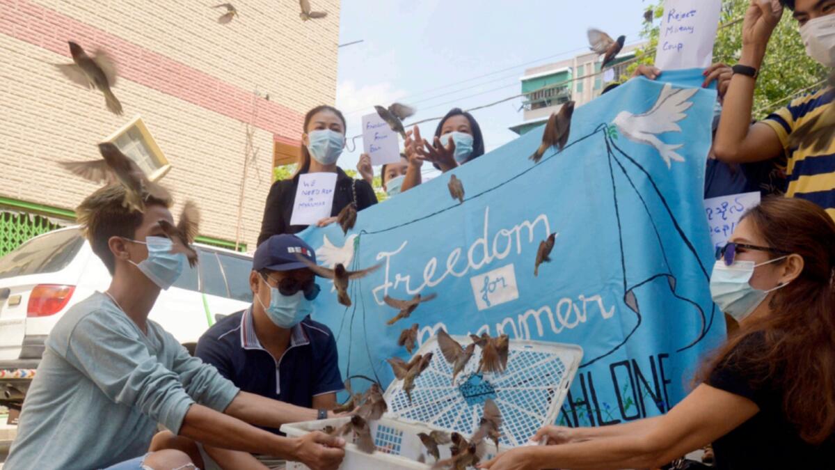 Protesters release birds as they remember those who have been killed during demonstrations against the military coup in Yangon. — AP