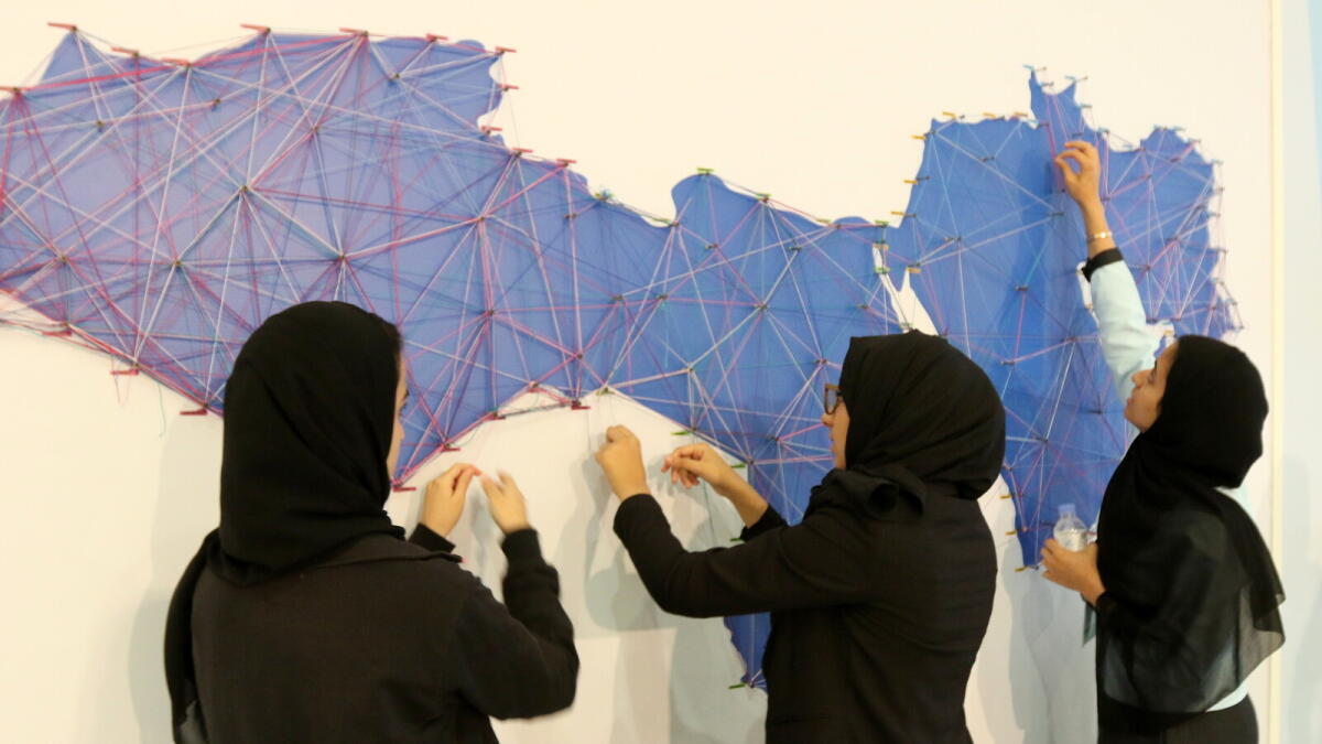 Students make a world map with threads during the second day of Investing in Future conference at Al Jawaher Reception and Convention Centre in Sharjah on Thursday. — Photo by M. Sajjad