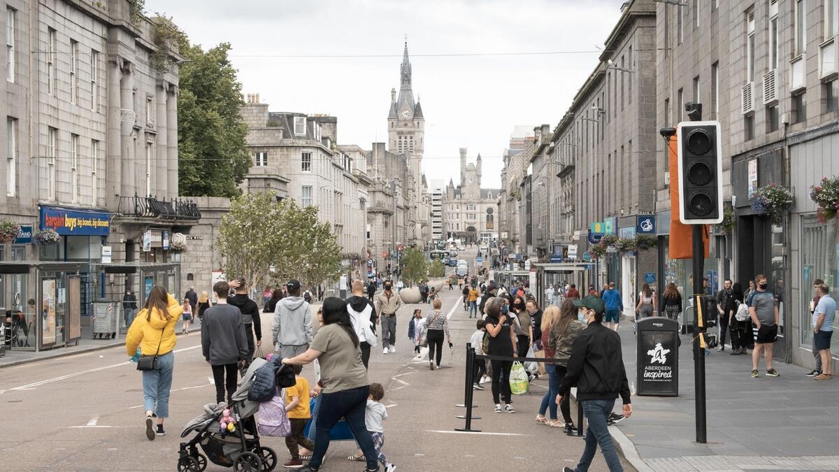 Residents walk in central in Aberdeen, eastern Scotland following the announcement that a local lockdown has been imposed on the city after a spike in the number of cases of novel coronavirus Covid-19. Scotland will re-impose lockdown restrictions in and around the city of Aberdeen after recording dozens of new coronavirus cases there this week. Photo: AFP